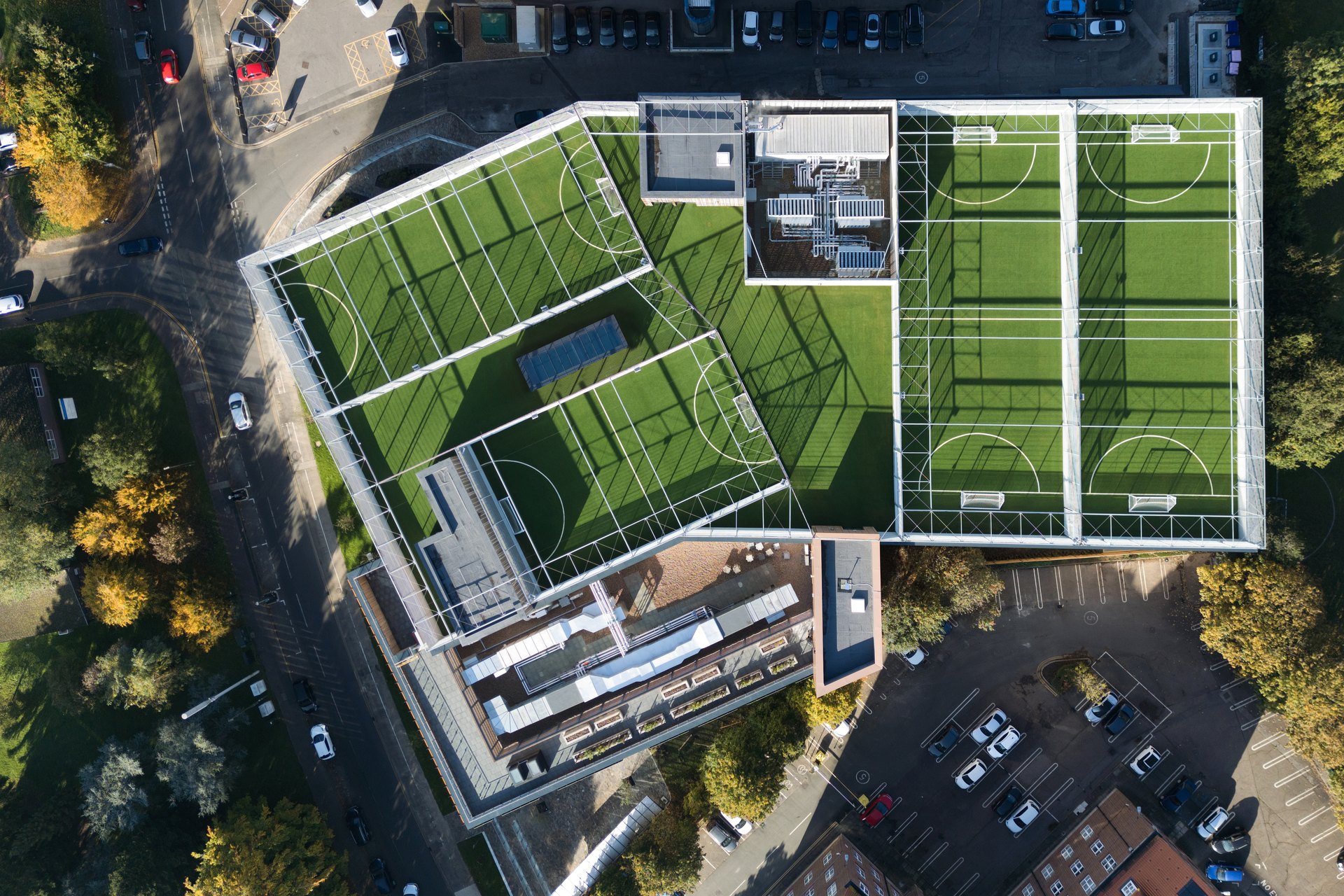 Aerial view of a commercial roof with attenuation areas and rooftop sports courts