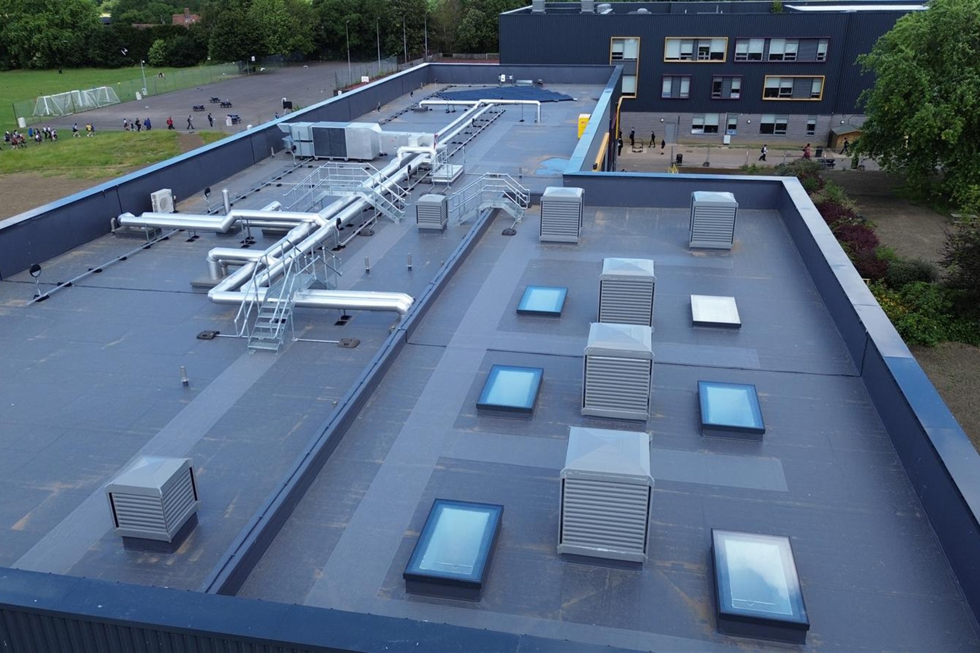 Commercial roofing team inspecting roof detail