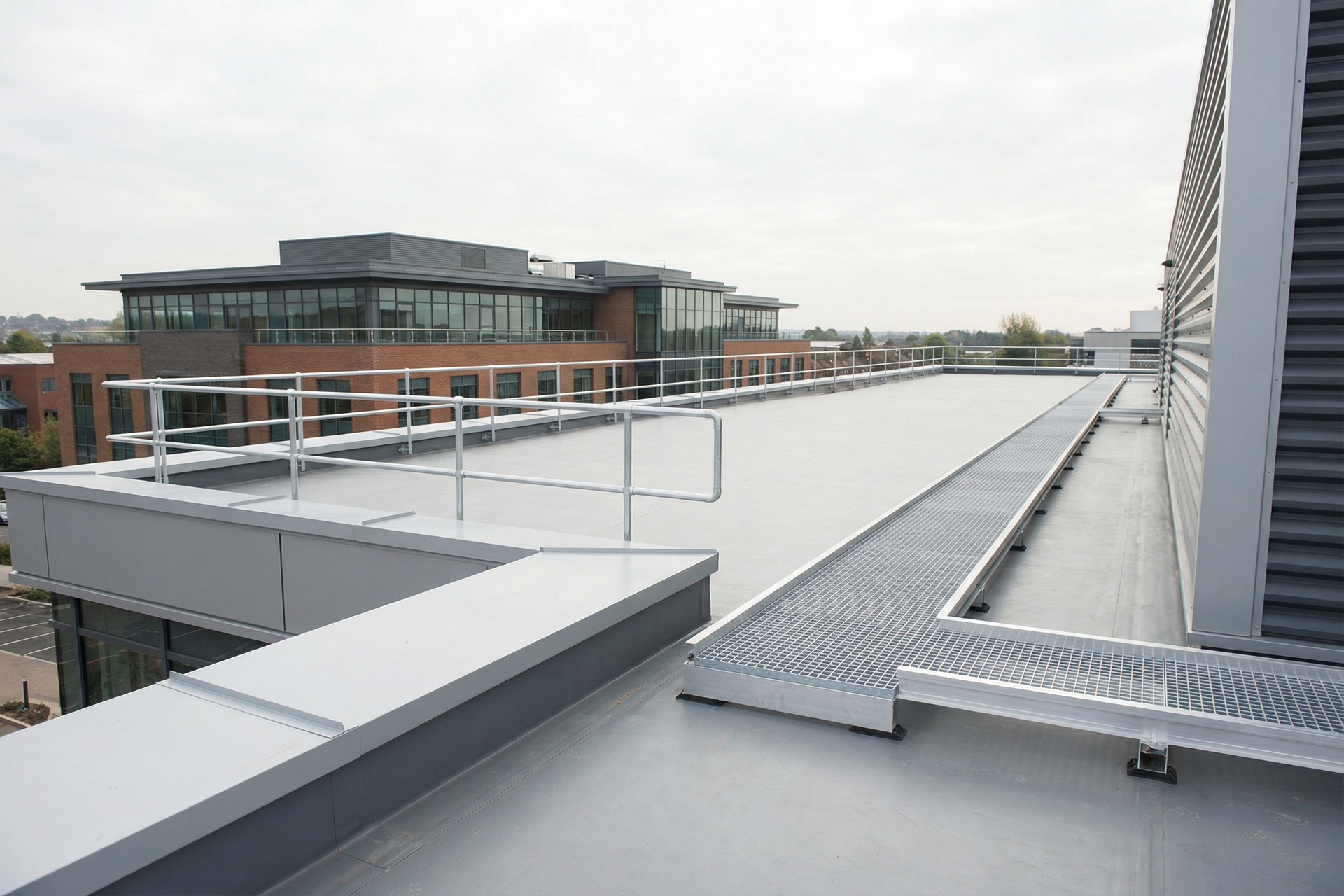 Completed commercial roof with safe access walkways and parapet detailing