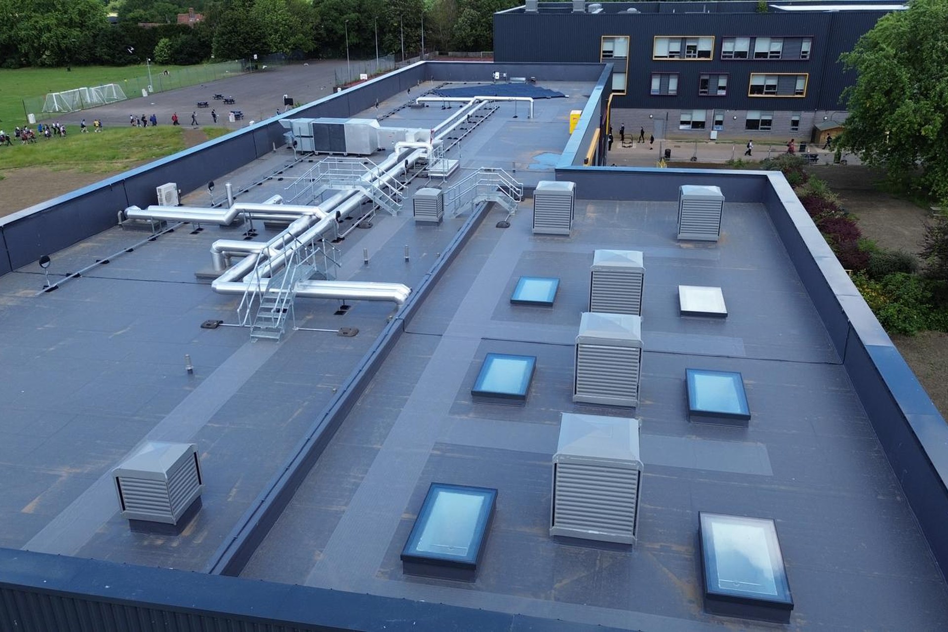 Single ply membrane roof with clean welded seams and parapet detailing